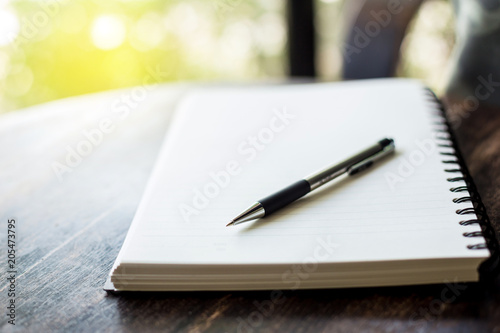 notebook and pen on a wooden table