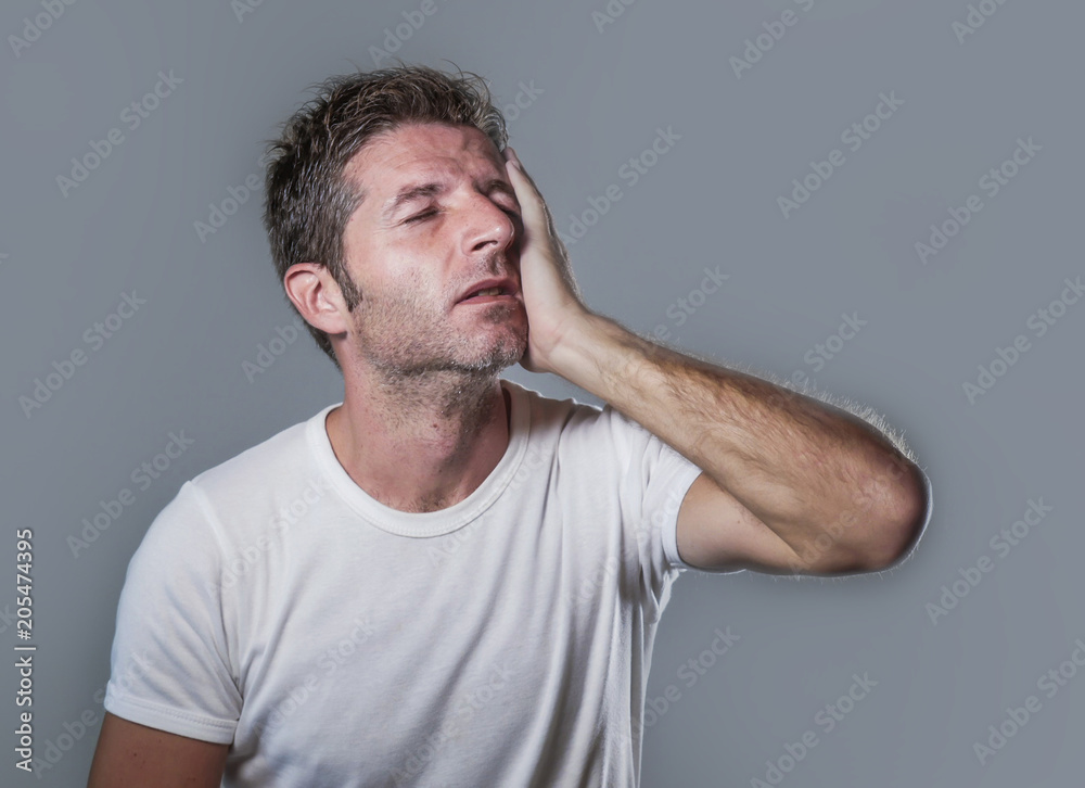 portrait of sad and depressed man with hand on face looking desperate feeling frustrated and helpless in depression and sadness facial expression portrait of sad and depressed man with hand on face looking desperate feeling frustrated and helpless in depression and sadness facial expression