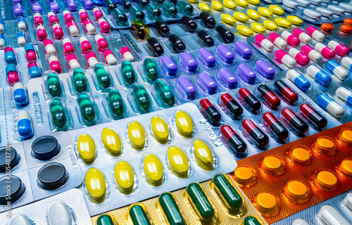 Colorful of tablets and capsules pill in blister packaging arranged with beautiful pattern. Pharmaceutical industry concept. Pharmacy drugstore. Defective and error in pharmaceutical factory concept.