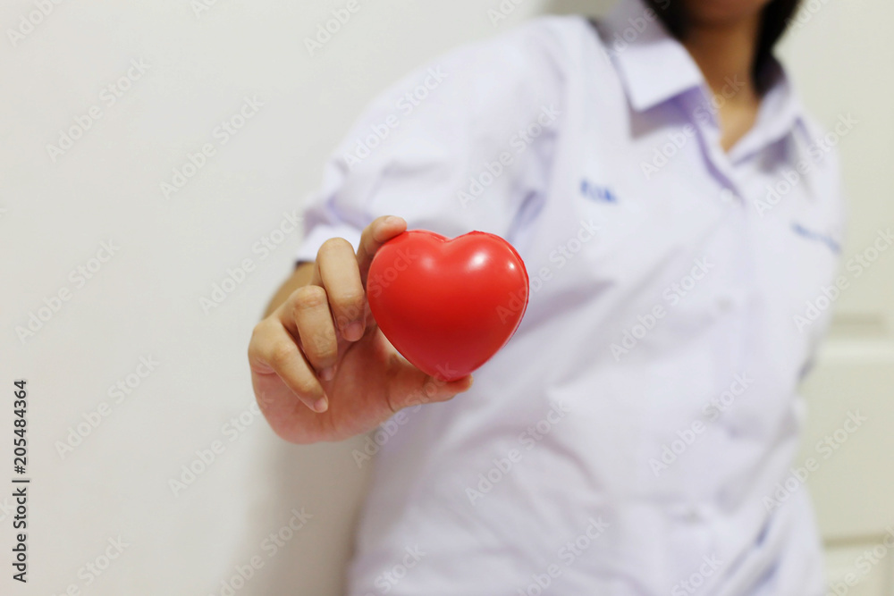 hand holding a red heart to give with love and romance on Valentine's day concept hand holding a red heart to give with love and romance on Valentine's day concept