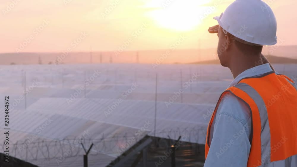 technical expert in solar energy photovoltaic panels, remote control performs routine actions for system monitoring using clean, renewable energy. concept of remote support technology technical expert in solar energy photovoltaic panels, remote control performs routine actions for system monitoring using clean, renewable energy. concept of remote support technology