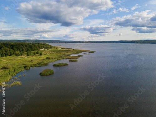 Drone view over forest, marsh and lake of Finjasjön, Automn in rural Sweden (Hässleholm)