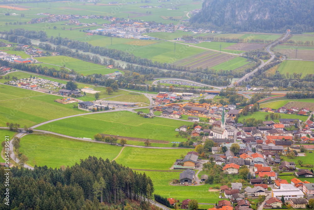 Aerial panorama of towns and highways in a valley surrounded by Alpine mountains south of Achensee in Tirol, Austria ~ Idyllic landscape of Tirolean countryside