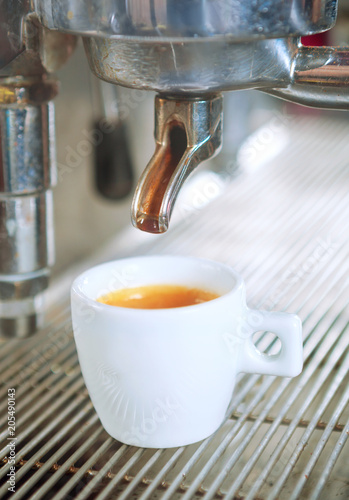 Close up of traditional Espresso Coffee Machine making cup of espresso coffee.