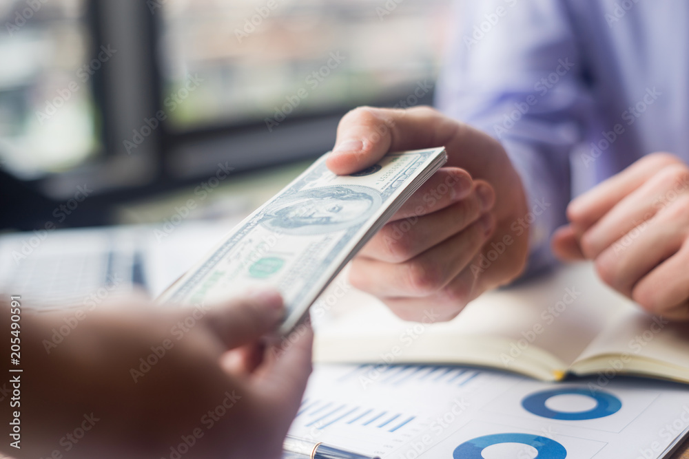 close up businessman giving money his partner in office, business concept close up businessman giving money his partner in office, business concept