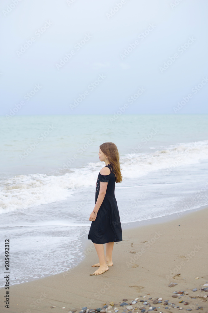 beautiful teen girl near the calm sea