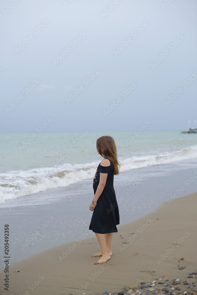 beautiful teen girl near the calm sea