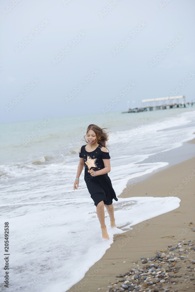 beautiful teen girl near the sea. littered the horizon beautiful teen girl near the sea. littered the horizon