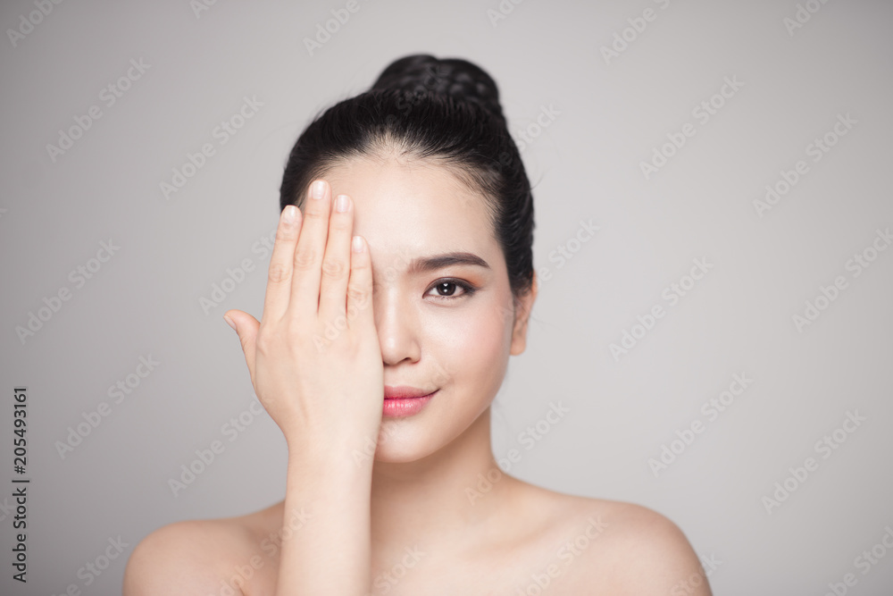 Happy smiling beautiful asian woman touching her face. Happy smiling beautiful asian woman touching her face.