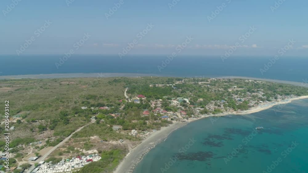 Tropical island with sandy beach, palm trees. Aerial view of coast island Pinget with colorful reef. Seascape, ocean and beautiful beach. Philippines, Luzon. Travel concept. Tropical island with sandy beach, palm trees. Aerial view of coast island Pinget with colorful reef. Seascape, ocean and beautiful beach. Philippines, Luzon. Travel concept.