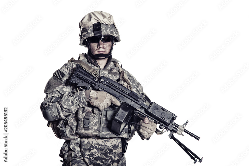 Low key studio portrait of US Armed Forces soldier in protective camouflage, helmet and tactical sunglasses holding light machine gun and looking in camera desaturated, isolated on white background Low key studio portrait of US Armed Forces soldier in protective camouflage, helmet and tactical sunglasses holding light machine gun and looking in camera desaturated, isolated on white background