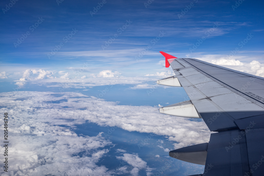 Beautiful clouds with blue sky, through airplane window, aircraft wing on a side. Beautiful clouds with blue sky, through airplane window, aircraft wing on a side.
