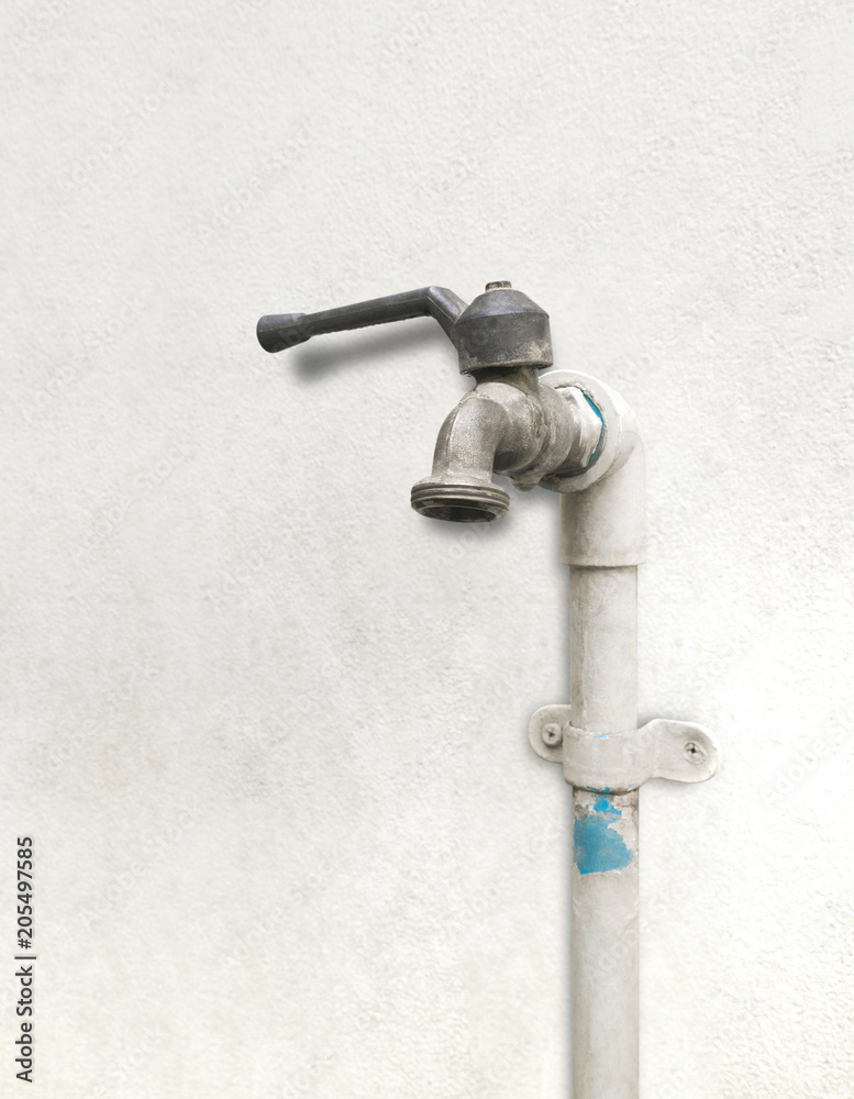 Old faucet isolated on white concrete wall. degraded Old faucet isolated on white concrete wall. degraded