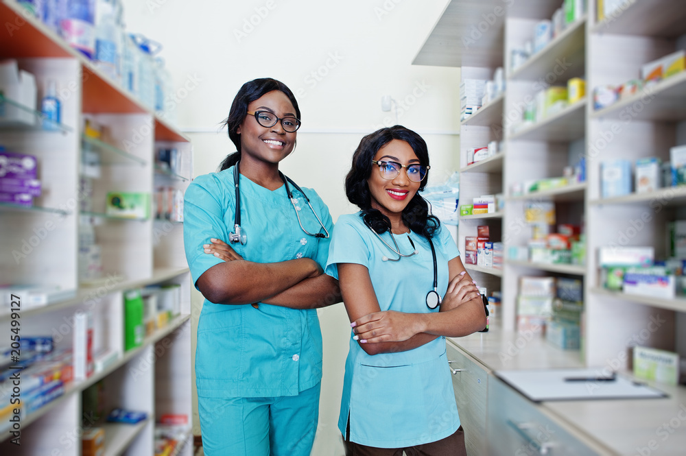 Two african american pharmacist working in drugstore at hospital pharmacy. African healthcare.