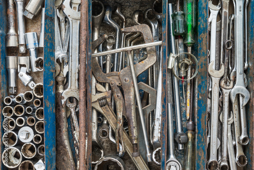 Many tools in rustic compartments toolbox. Technical machanic toolset for car automobile, motorcycle repair or DIY.