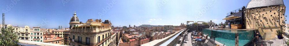 BARCELONA - MAY 11, 2018: Tourists enjoy city view from a rooftop. Barcelona attracts 10 million tourists annually