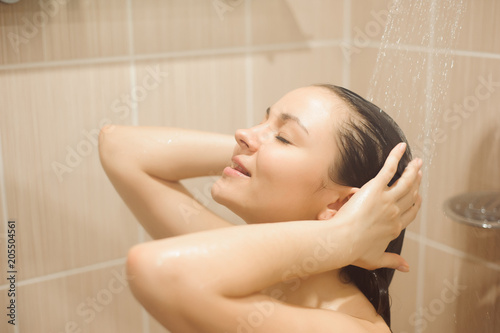 Woman with long hair taking shower.