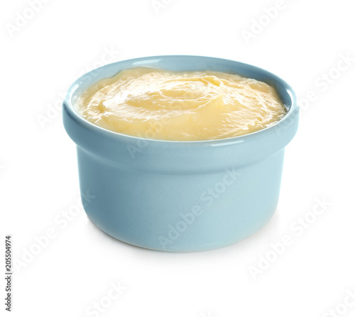 Tasty vanilla pudding in ramekin on white background