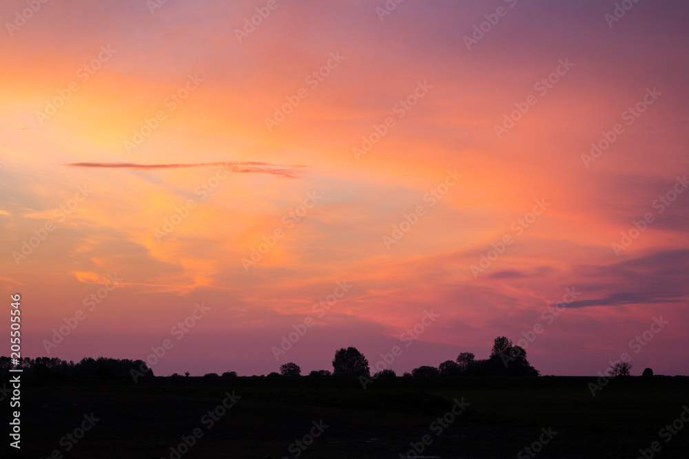 Natural Sunset Sunrise Over Field Or Meadow. Bright Dramatic Sky And Dark Ground. Countryside Landscape Under Scenic Colorful Sky At Sunset Dawn Sunrise. Sun Over Skyline, Horizon. Warm Colours. Natural Sunset Sunrise Over Field Or Meadow. Bright Dramatic Sky And Dark Ground. Countryside Landscape Under Scenic Colorful Sky At Sunset Dawn Sunrise. Sun Over Skyline, Horizon. Warm Colours.