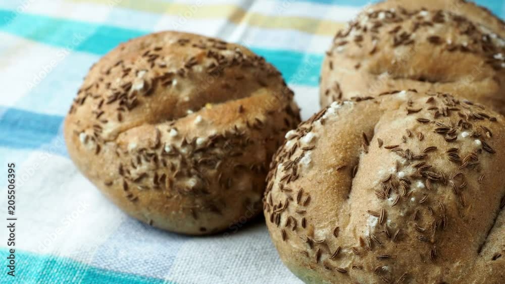 Bread rolls sprinkled with salt and caraway. Freshly baked pastry. Bread rolls sprinkled with salt and caraway. Freshly baked pastry.