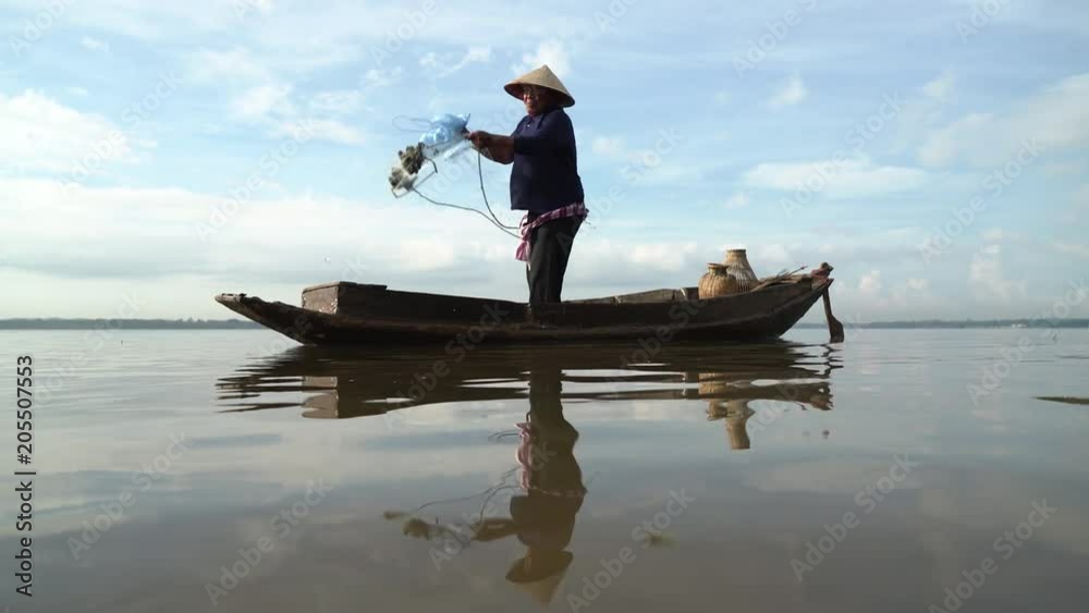 Fishermen on a rowing boat are fishing with a net. Fishermen on a rowing boat are fishing with a net.