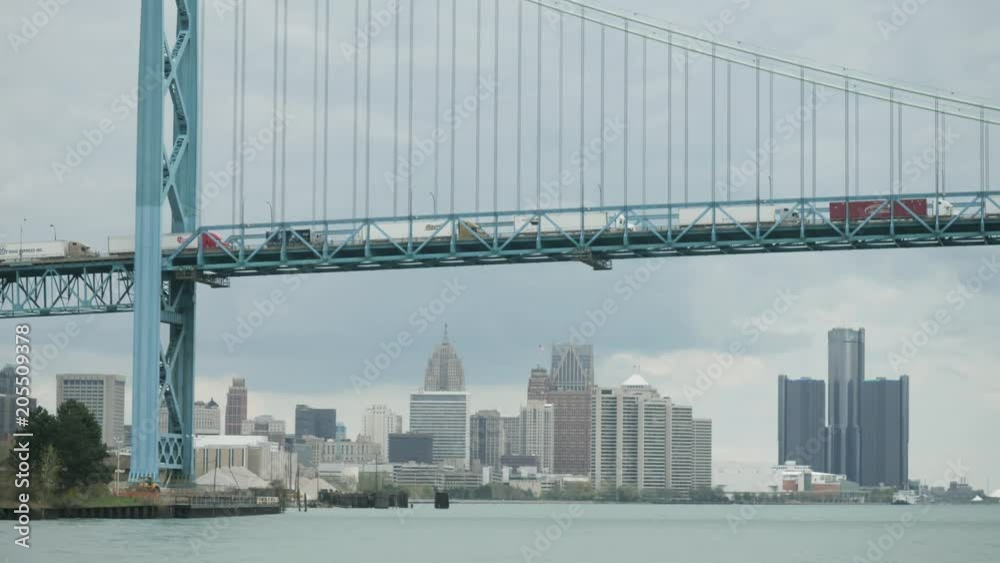 View of Ambassador Bridge over the Detroit river with downtown Detroit in the background View of Ambassador Bridge over the Detroit river with downtown Detroit in the background