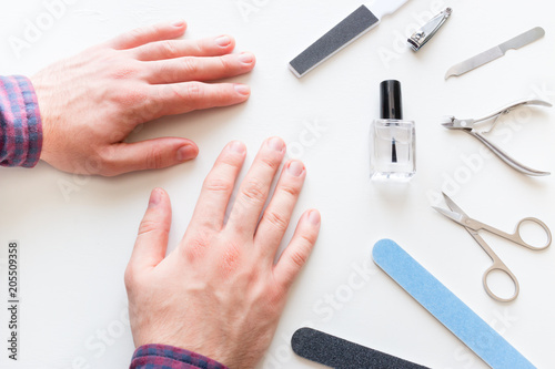 man with not well-groomed nails in the salon of manicure photo