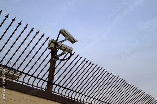 Photography Security surveillance camera on the fence.
