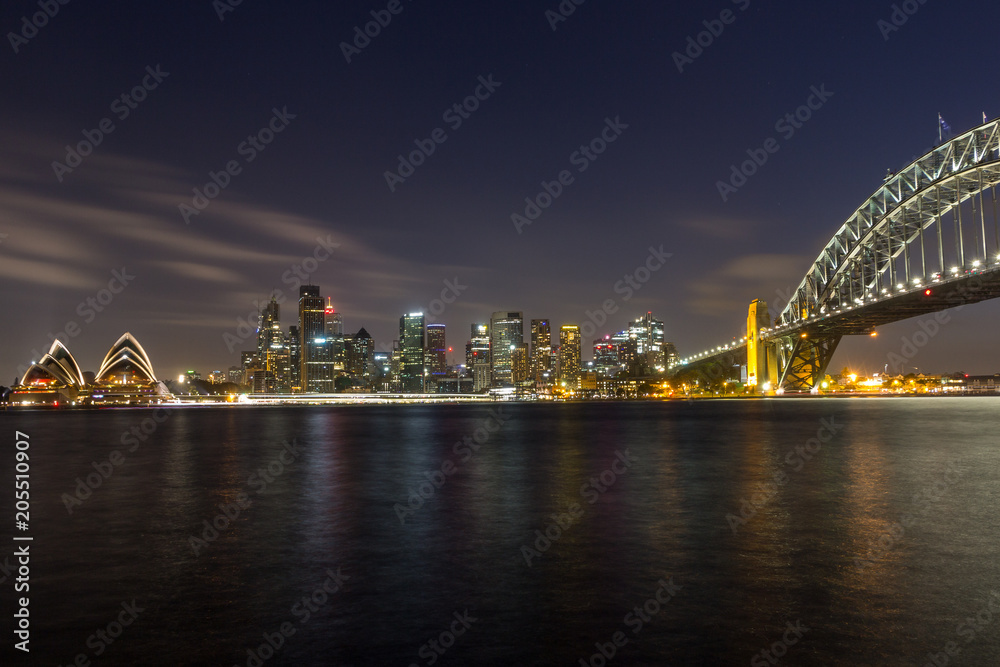 opera house and harbour bridge in Sydney at night, It is illuminated by golden lights . Australia : 31/03/18