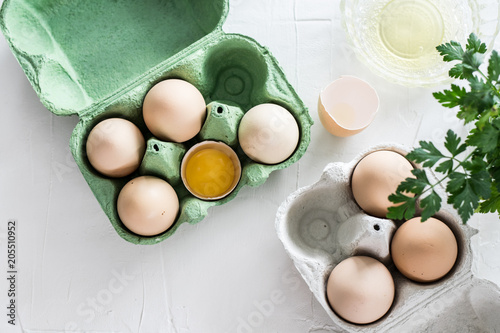 Brown eggs in white cartons on concrete background