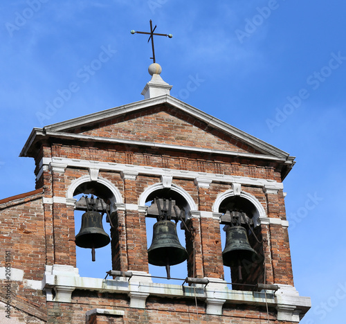 red brick bell tower with three metal bells