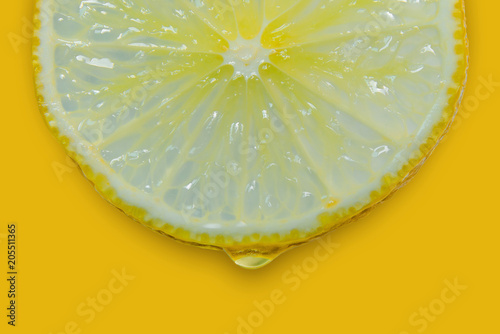 Lemon and lime slice and fresh citrus fruit on yellow background.
