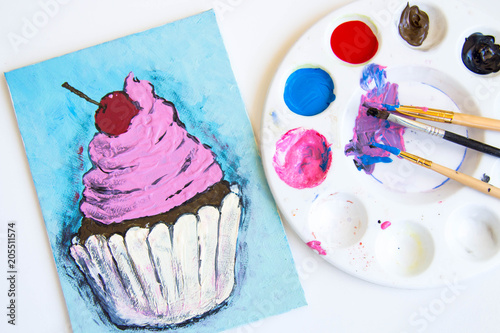 small canvas painting with paints beside it