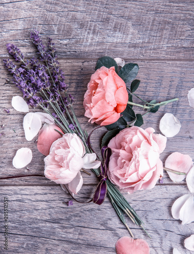 Fototapeta Naklejka Na Ścianę i Meble -  Festive flower English roses composition with ribbon, lavender on wooden background, rustic style. Overhead top view, flat lay. Copy space. Birthday, Mother's, Valentines, Women's, Wedding Day concept