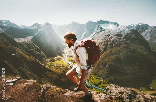 Man with backpack skyrunning in mountains landscape Traveling Lifestyle adventure vacations in Norway hiking sport