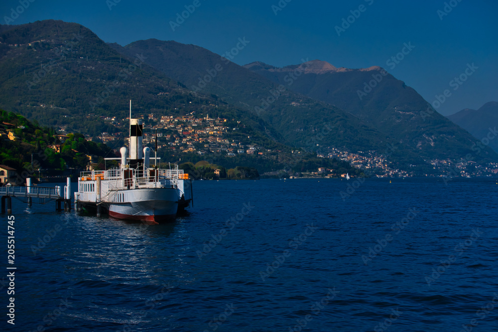 Boat for public navigation moored on the lakefront of Como, Italy.