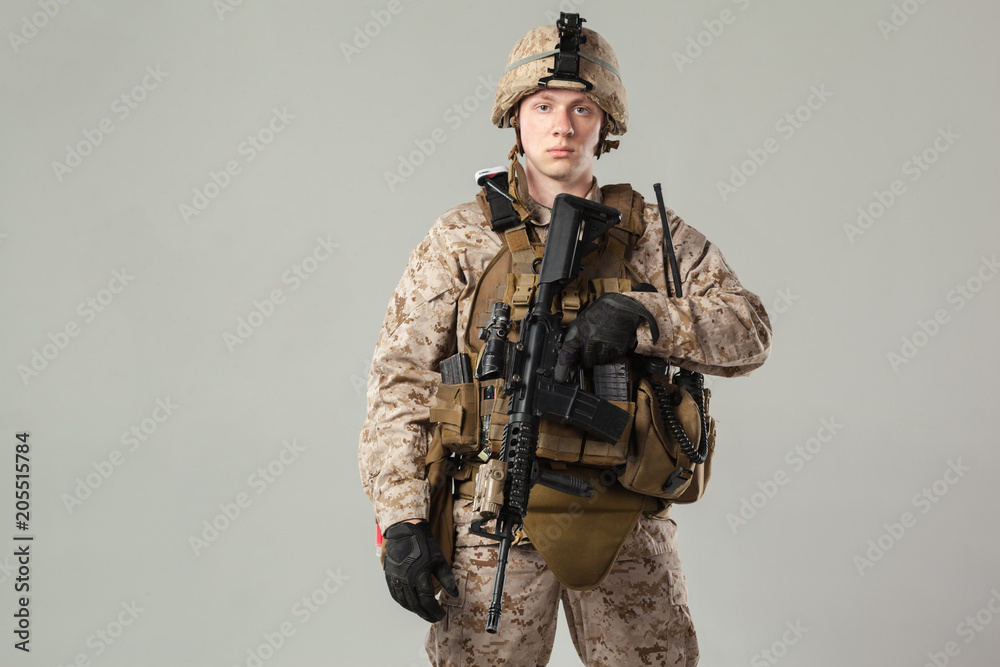 Soldier in camouflage holding rifle Soldier in camouflage holding rifle