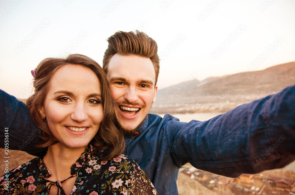 couple in love do the selfie on the background of hills and river. couple in love do the selfie on the background of hills and river.