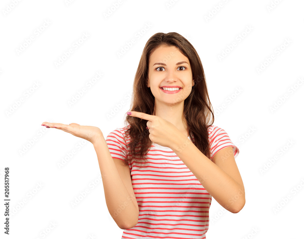 Smiling and happy woman, looking to you camera ahead and showing with index finger hand to the left copy space. Look here concept. emotional girl isolated on white background Smiling and happy woman, looking to you camera ahead and showing with index finger hand to the left copy space. Look here concept. emotional girl isolated on white background