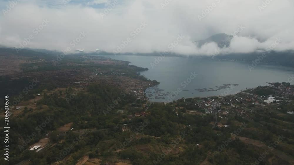 Lake Batur in the crater of a volcano. Aerial view of volcano mount and lake Batur located in Kintamani area in Bali, Indonesia. Landscape, lake, mountains, clouds. 4K video. Travel concept. Aerial Lake Batur in the crater of a volcano. Aerial view of volcano mount and lake Batur located in Kintamani area in Bali, Indonesia. Landscape, lake, mountains, clouds. 4K video. Travel concept. Aerial