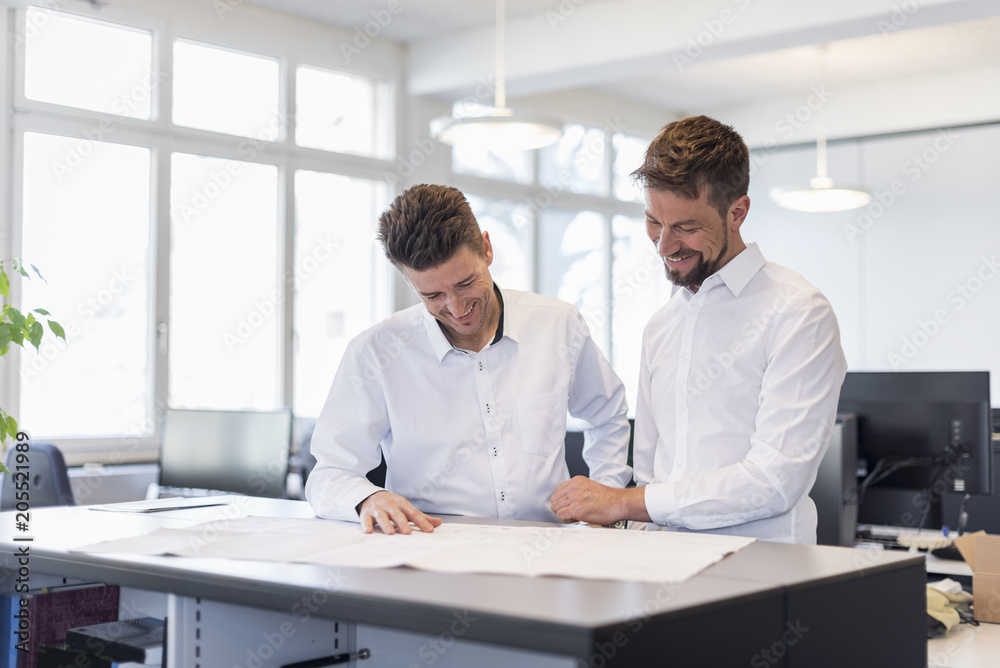 Two businessman having a meeting in office Two businessman having a meeting in office