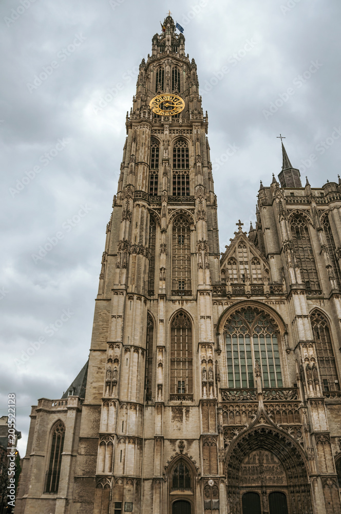 Fototapeta premium Bell tower and gothic facade of the Cathedral of Our Lady in Antwerp. Port and multicultural metropolis, it is known as one of the main European gateways for goods in Europe. Northern Belgium.