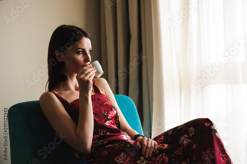 Closeup portrait of beautiful woman drinking coffee
