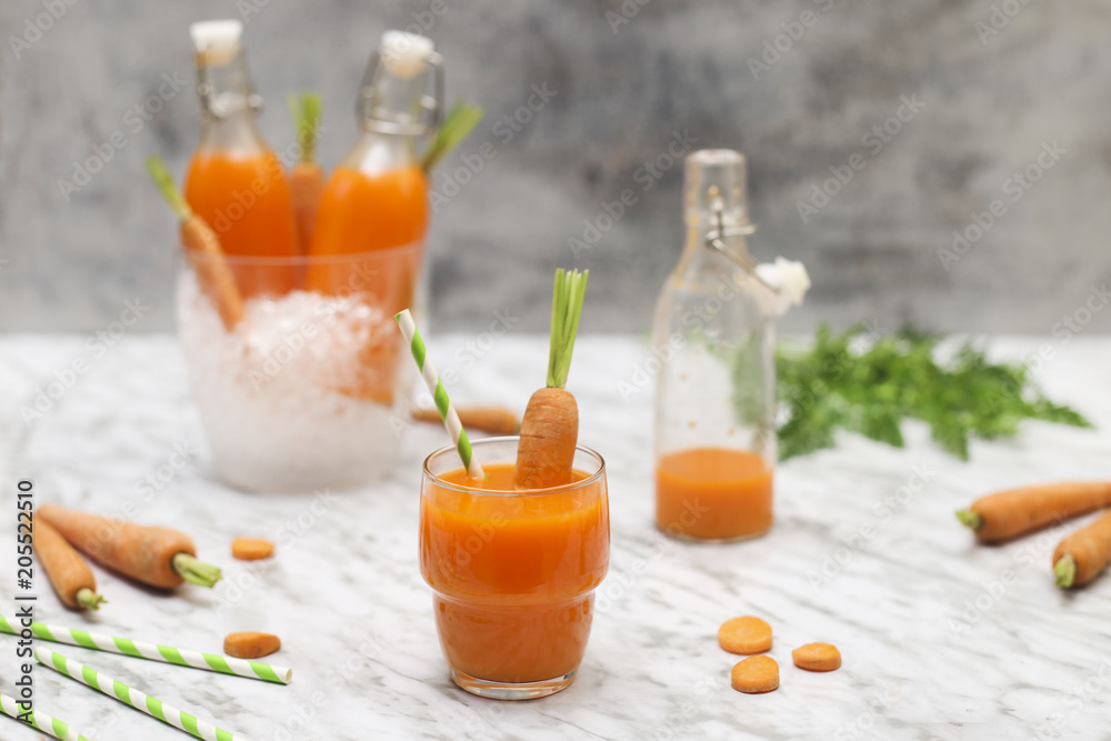 Refreshing carrot juice on marble Refreshing carrot juice on marble