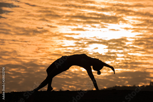 Fototapeta Naklejka Na Ścianę i Meble -  Silhouette Asia woman yoga on sunset. Sunset sky background