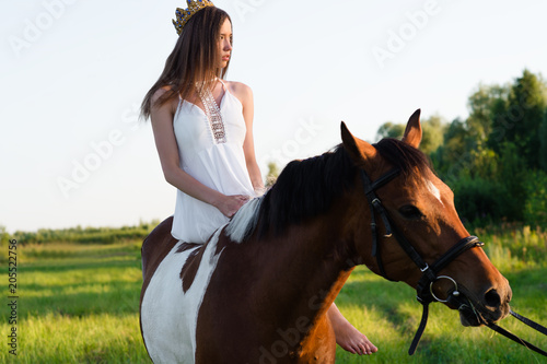 beautiful girl in white dress sitting on horse  © Ruslan Solntsev