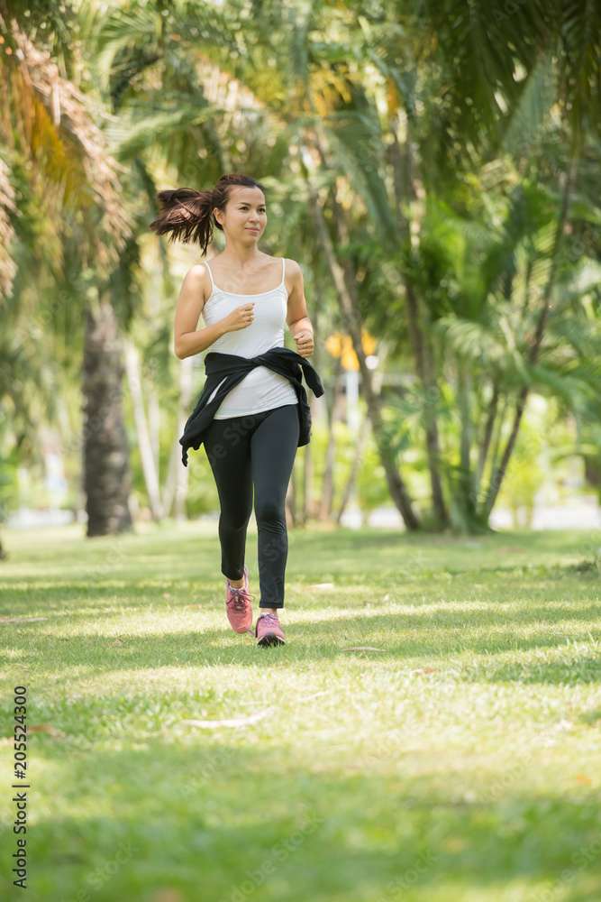 Pretty sporty woman jogging at park