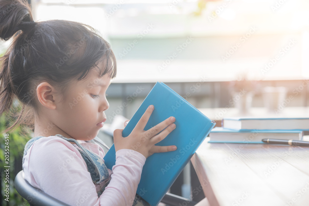 cute smiling kid reading book in children room cute smiling kid reading book in children room
