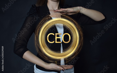 In the hands of a businessman, a neon circle with the inscription:CEO