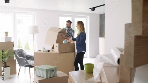 Cheerful couple moving in the new apartment